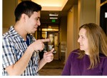 Young man signing to woman