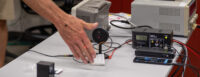 Equipment on a table at an event teaching the community about optics technology
