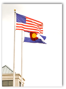 US and Colorado flags flying