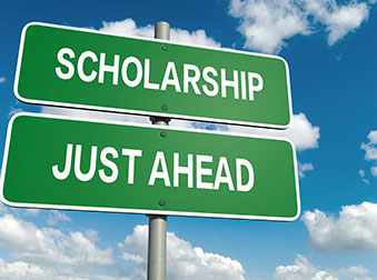 road sign: "scholarship just ahead"