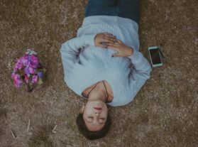 person lying on ground relaxing