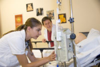 Nursing student checking on IV
