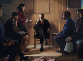 District Attorney surrounded by legal team