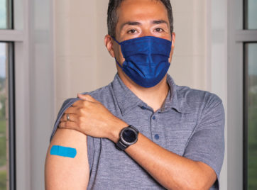 Chico Garcia showing the vaccine band aid on his arm