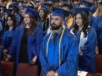 Graduate Alex Rodriguez in front of the crowd of graduates