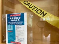 Banned books display with caution tape