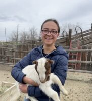 Nora holding a goat.