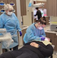 dental hygienist working on patient in FRCC dental clinic