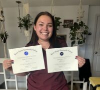 Cydnee holding her certificates from FRCC